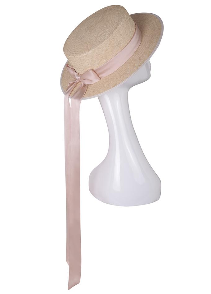 Women's Panama straw boater hat with long pink silk ribbons on mannequin