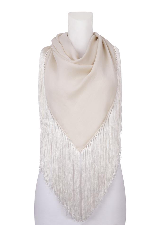 Extra large tasselled scarf and face covering in cream silk blend on mannequin