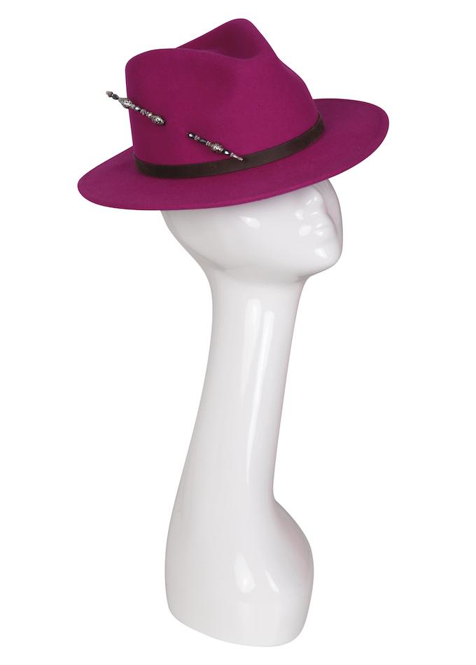Magenta felt fedora with embellished hat pin on mannequin