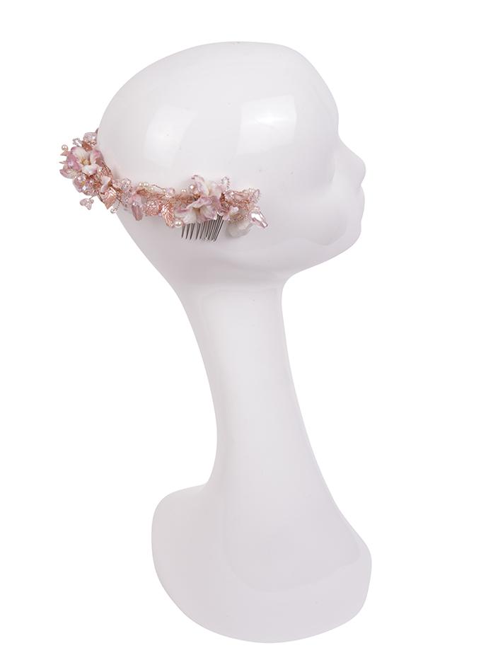 Pink beaded headpiece with flowers on mannequin