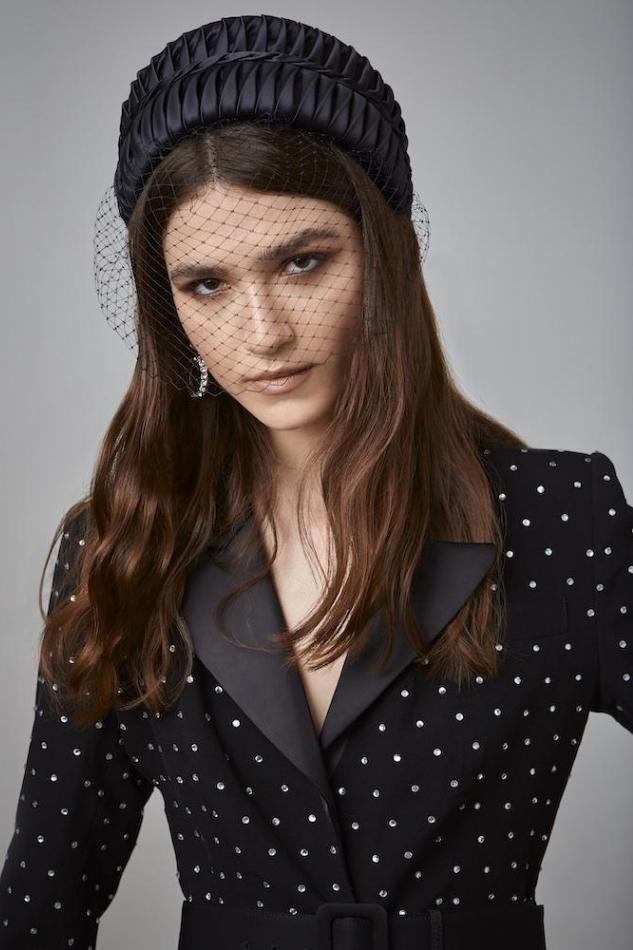 Black Portia Headpiece from Emily London Luxury headwear collection worn by model wearing a black dotted dress