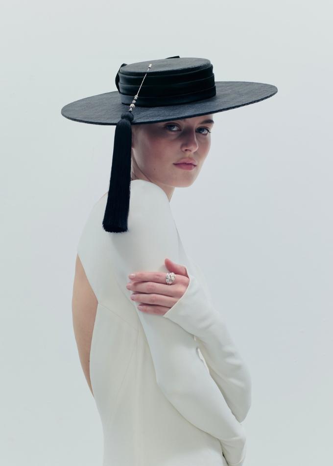 Model image of black straw Batista wide brim boater hat with silk band and jewelled hat pin