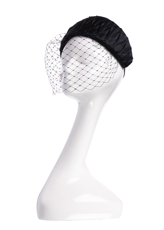 Black smocked silk hatband with removable veil on mannequin