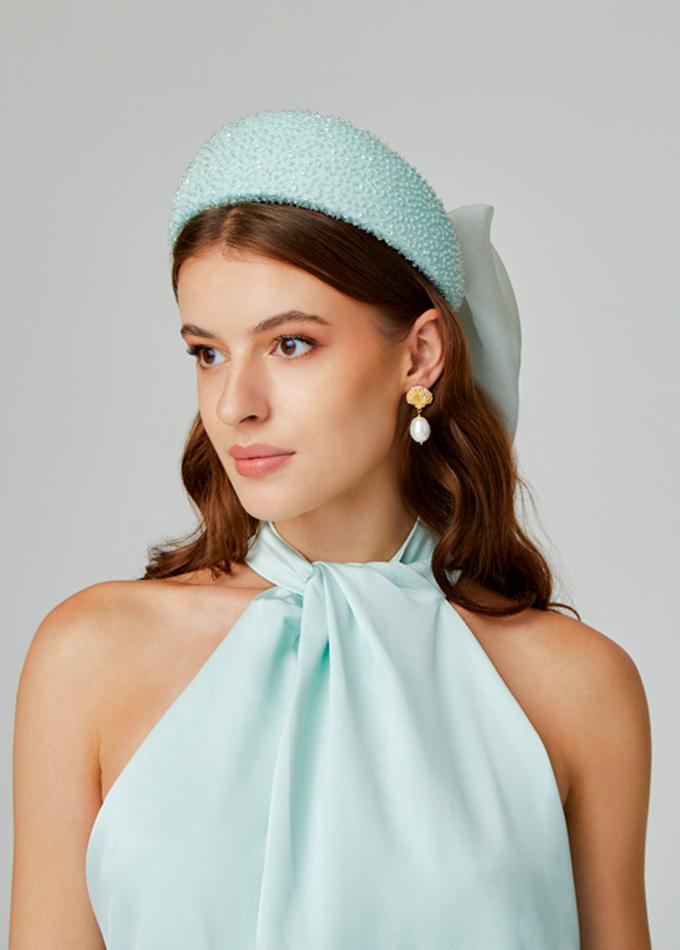 Acqua embellished hatband with silk organza bow on model