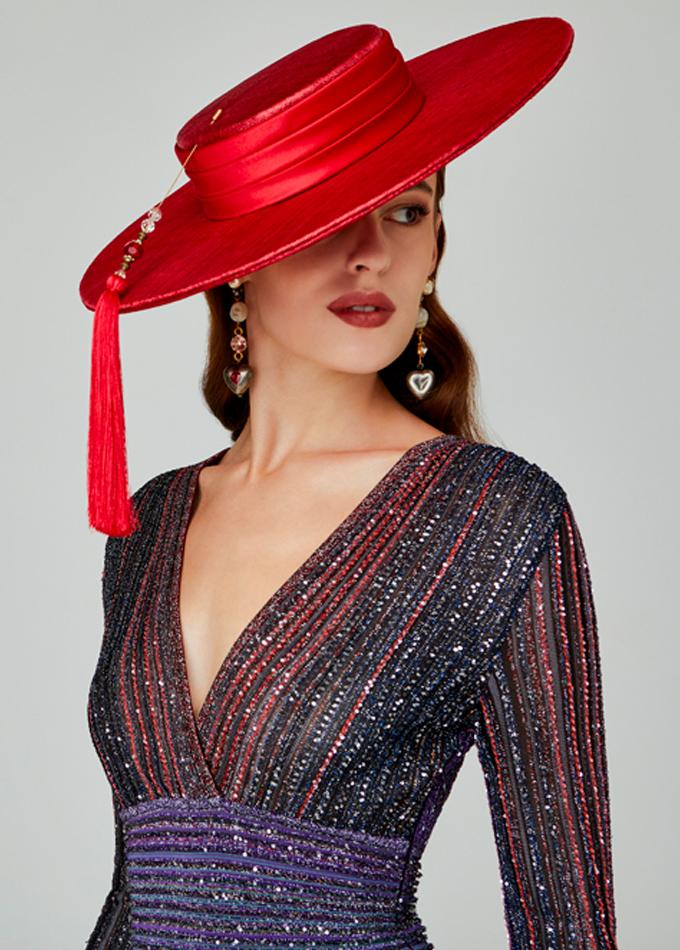 Red straw wide-brimmed boater with jewelled tassel hatpin on model