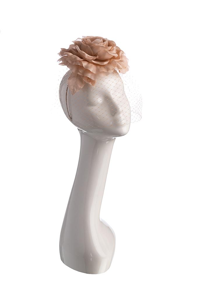 Nude silk flower headpiece with face veil on mannequin