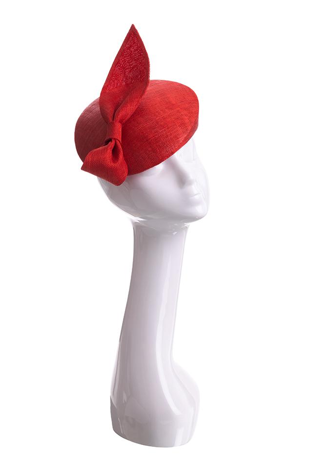 Red straw beret pillbox hat with straw knot on mannequin