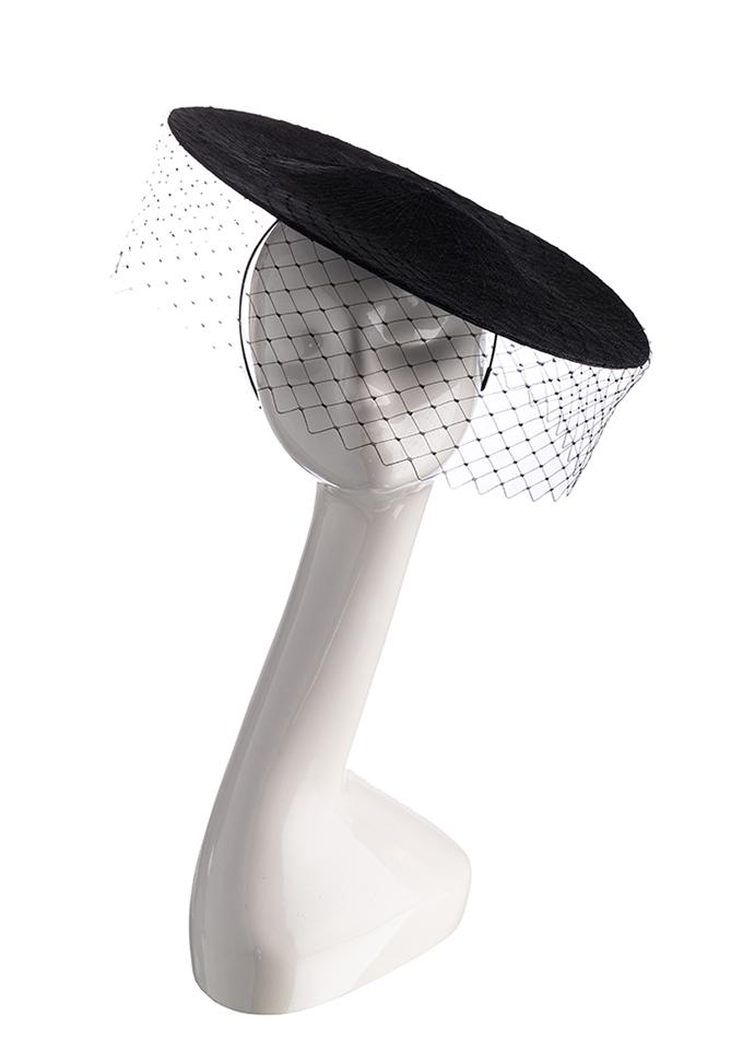 Black straw disc hat with veil on mannequin