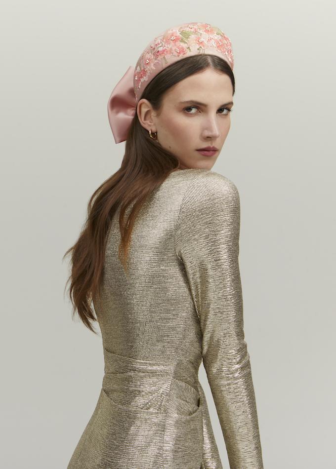 Blush pink embroidered floral headpiece with bow on model