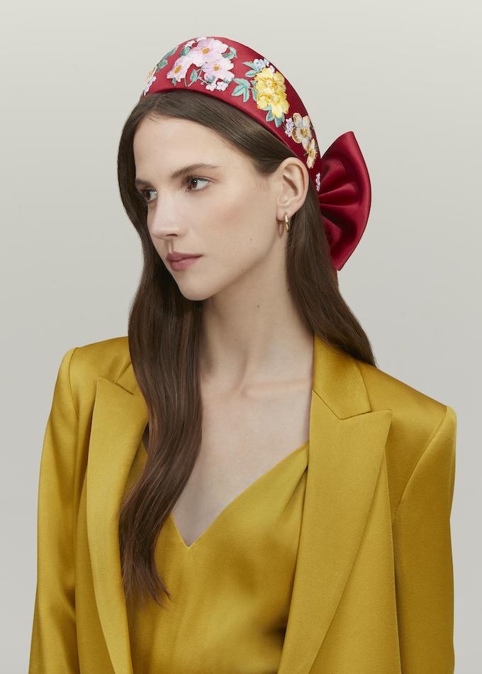 Red silk embroidered floral headpiece with bow on model