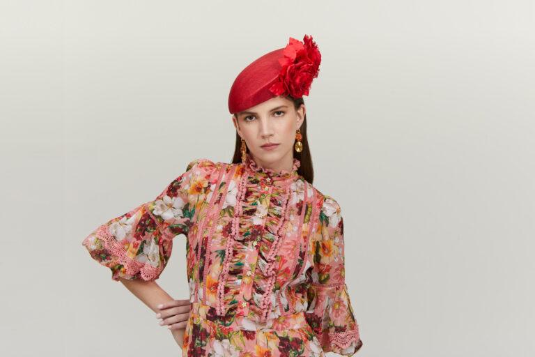 red pillbox hat with floral embellishment by Emily London