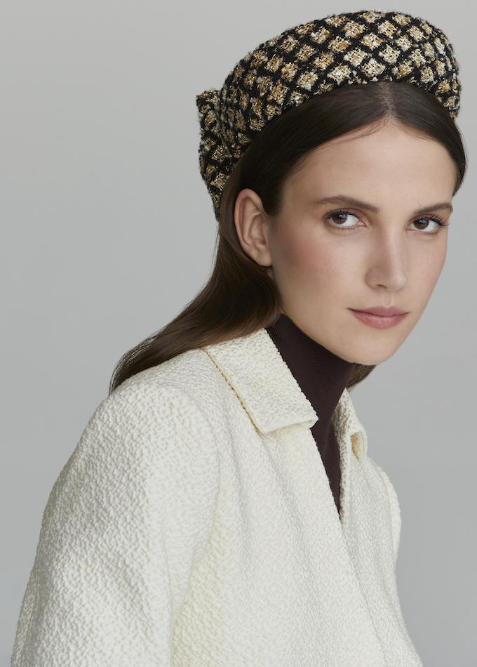 Emily-London pillbox hat in black and gold bouclé on model