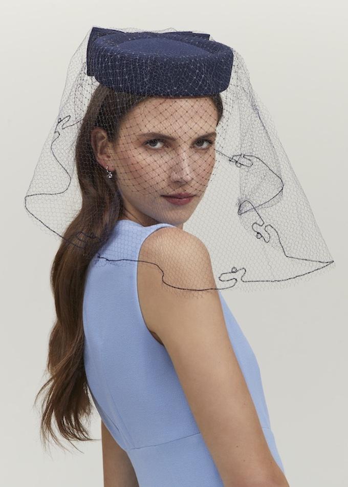 navy pillbox hat with a bow and a long veil