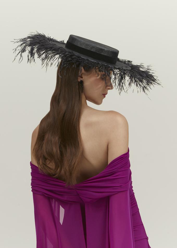 Emily-London black wide-brimmed hat with black feathers on model