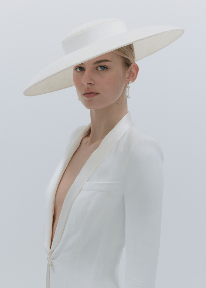 Model image wearing white straw wide brim Marina hat with tailored silk band