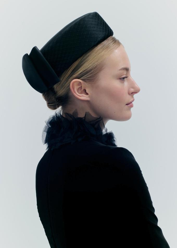 Model image of Aveline black silk pillbox hat with tailored silk bow