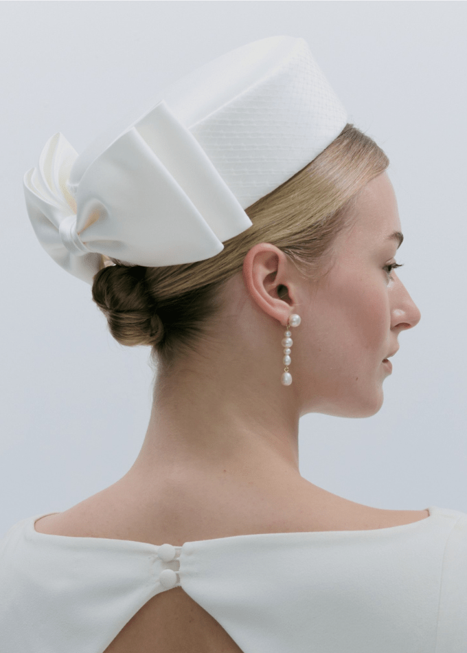 CLOSE-UP Model image of white Aveline silk pillbox hat with tailored bow