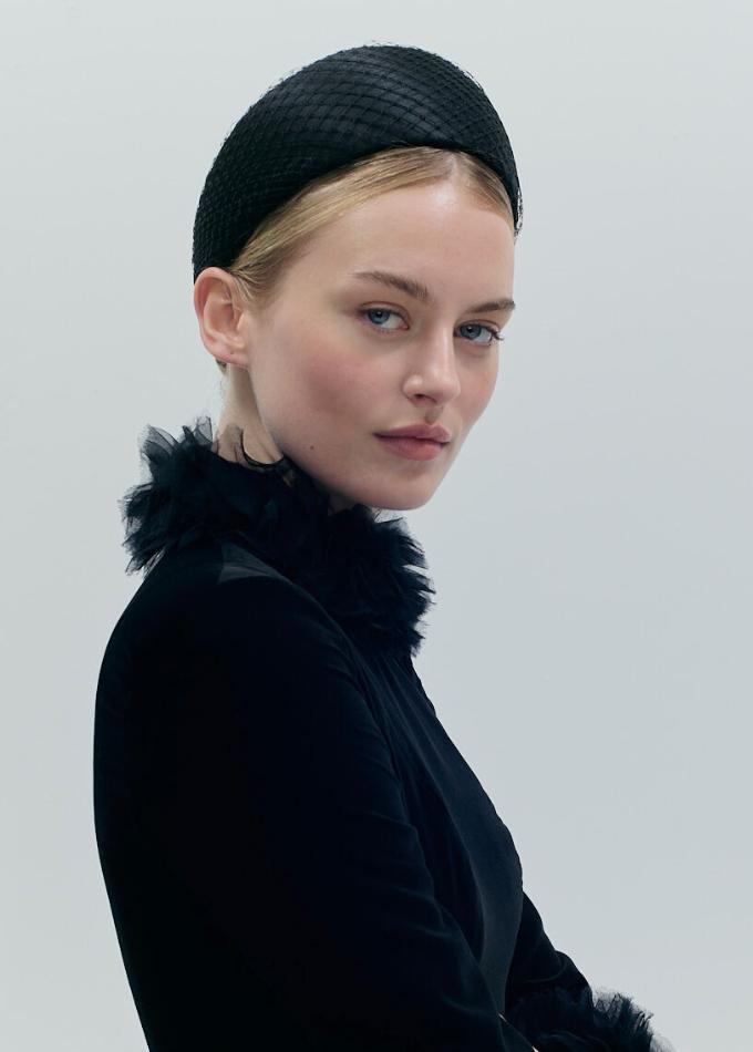Model image of black Manon headpiece in silk with wrapped veiling