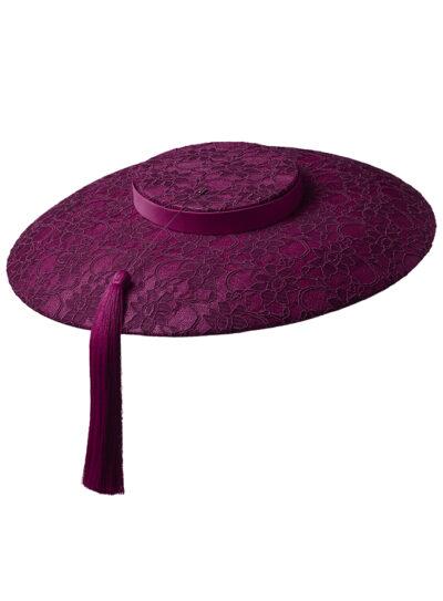Magenta wide brim straw hat with lace detail on the brim and crown and a magenta tassel hat pin