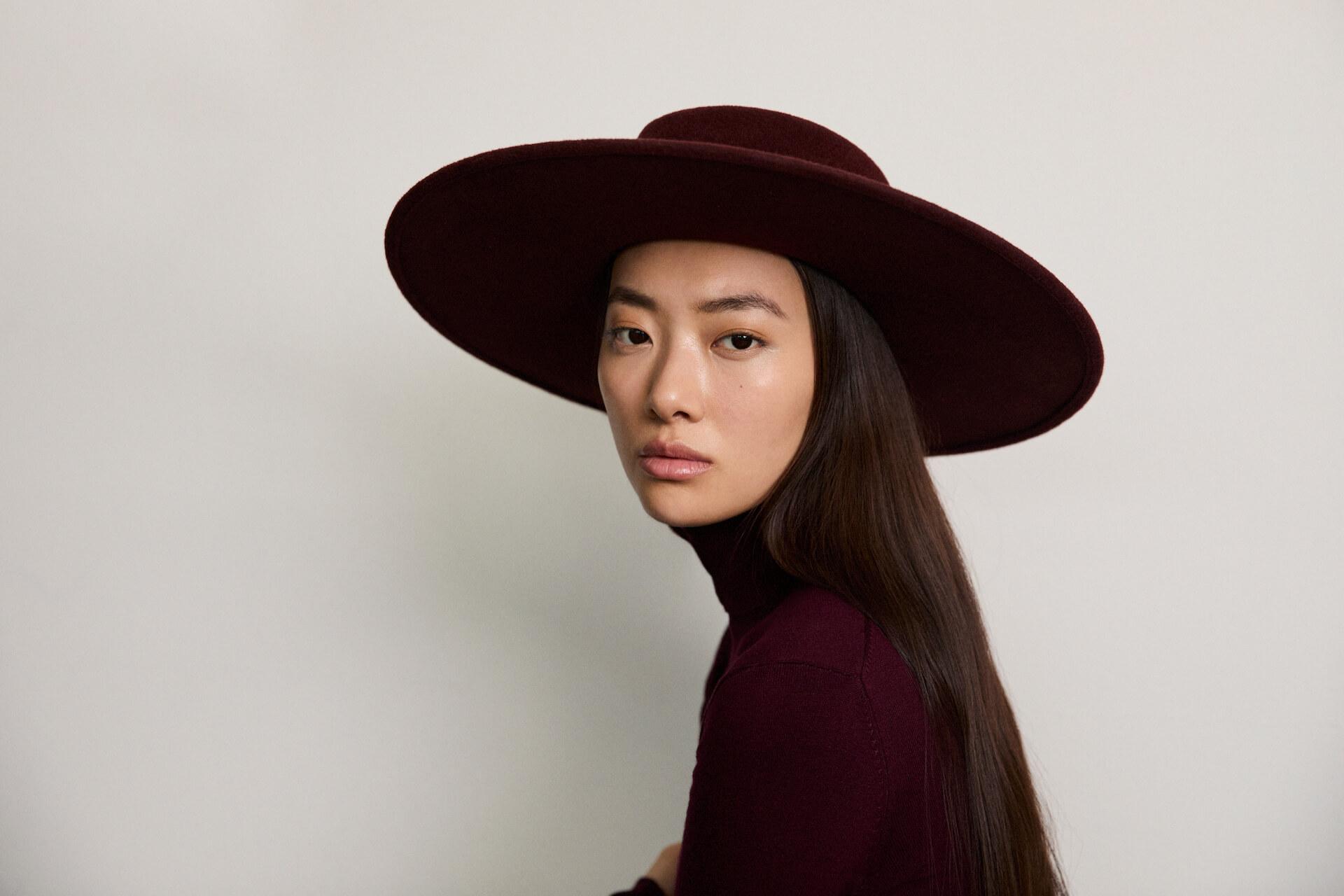 model shot of woman wearing burgundy Mateo boater hat