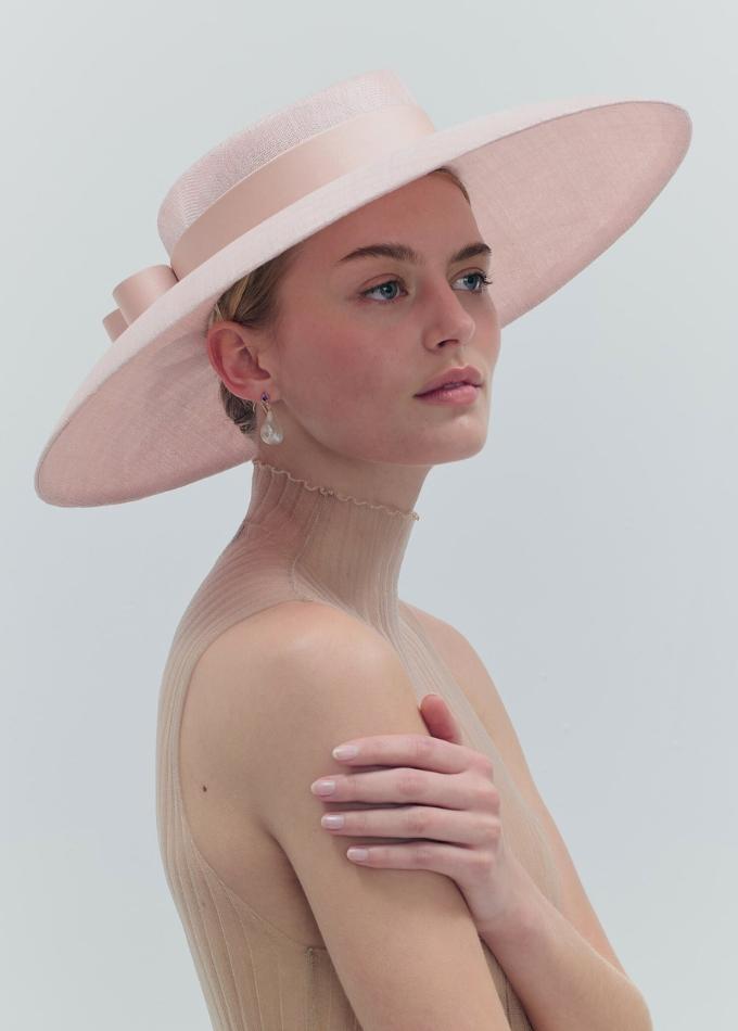 Model image of Donna light pink straw wide brimmed hat with tailored silk band and double bow