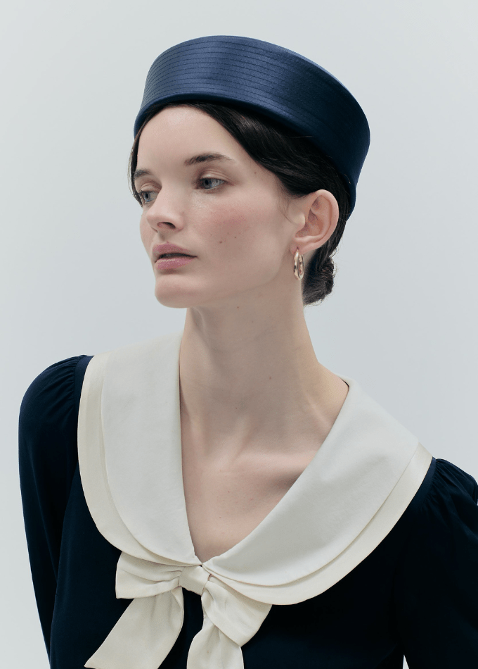 Model image of navy silk Amal pillbox